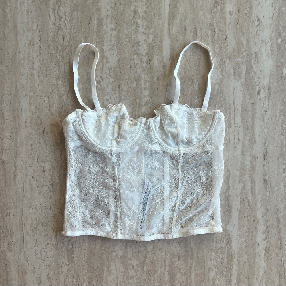 Out from under white lace corset